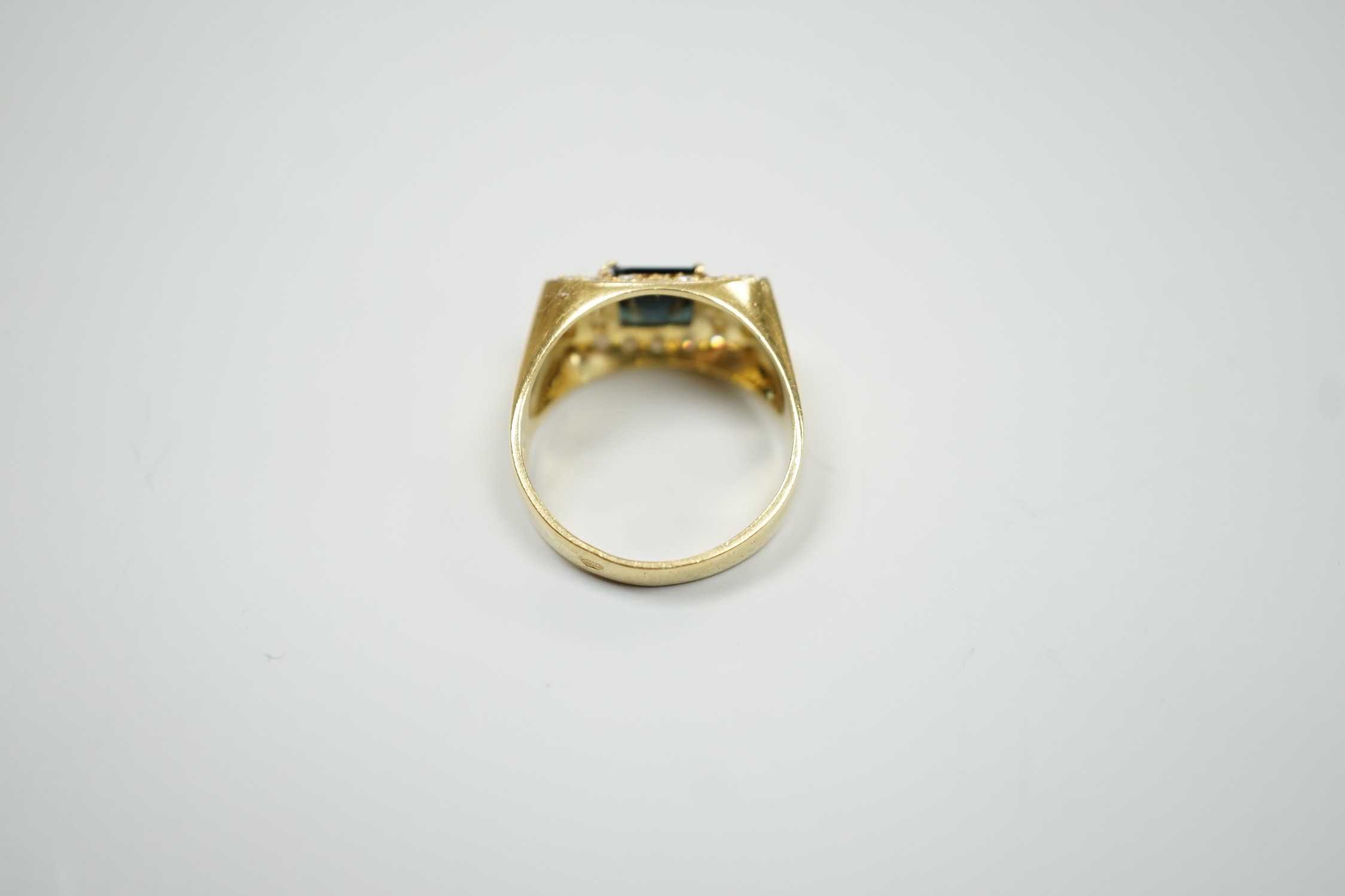 A modern 750 yellow metal, single stone sapphire and pave set diamond dress ring, size O, gross weight 5.9 grams.